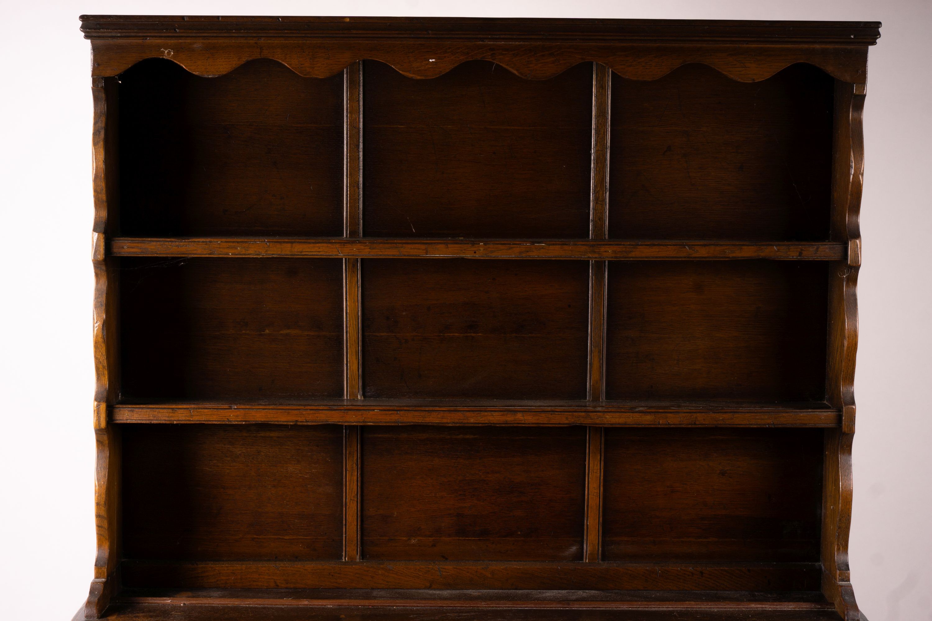 An 18th century style carved oak dresser, width 124cm, depth 46cm, height 175cm